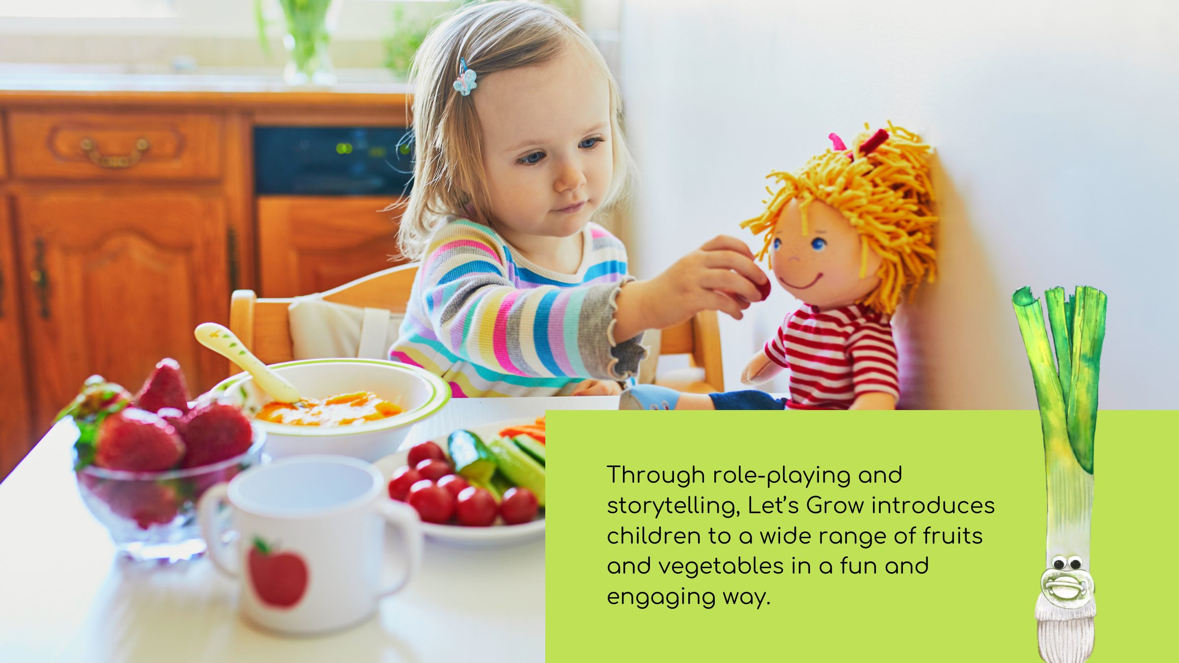 A very young girl, sitting at a table with strawberries, tomatoes, cucumber, carrot and peaches, playing with her doll.